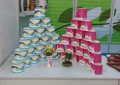 Branded yogurt cups showcased in an eye-catching pyramid arrangement at the exhibition booth